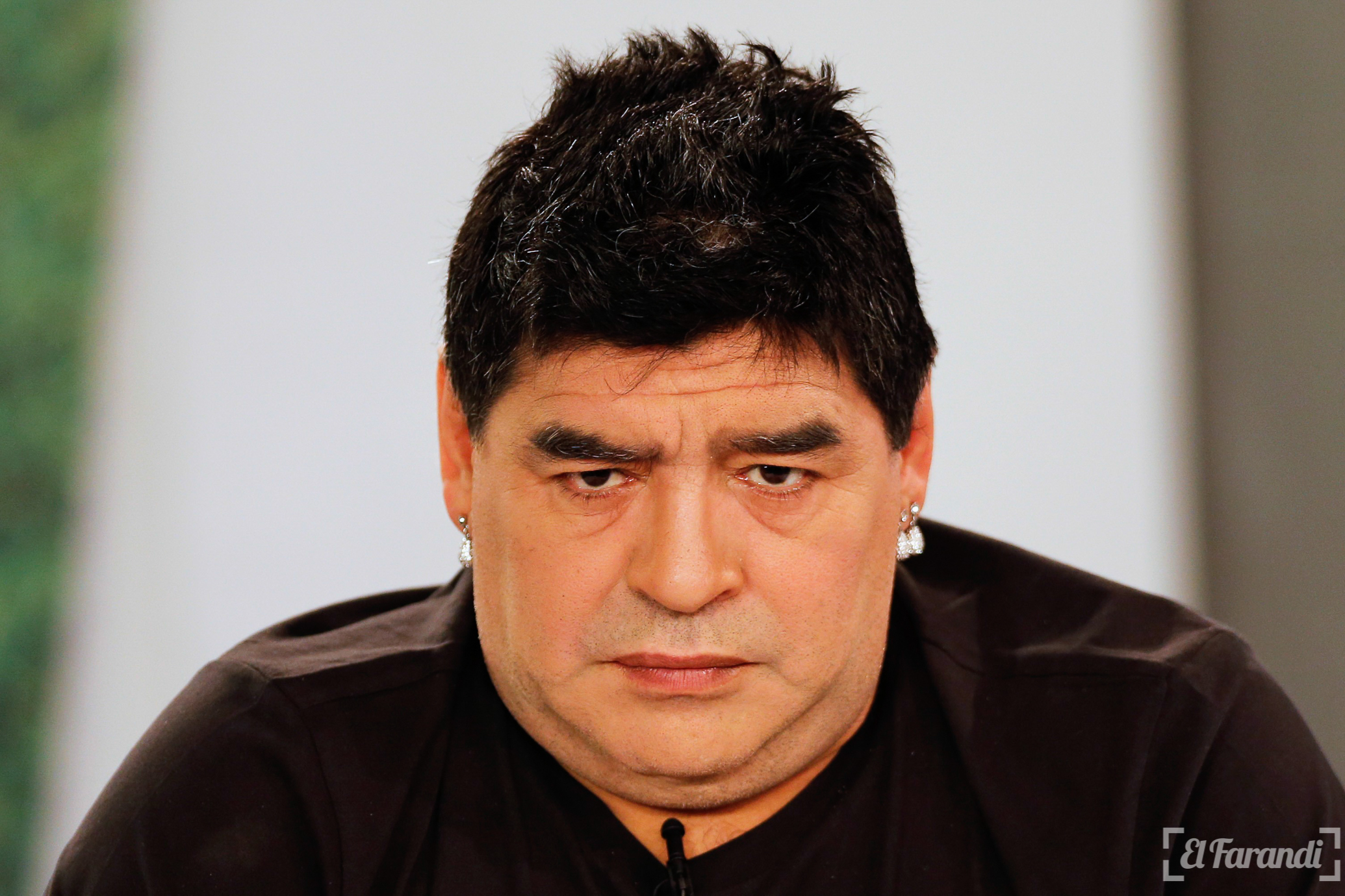Argentina's soccer legend Diego Maradona looks on as he hosts his television show 'De Zurda' in Caracas