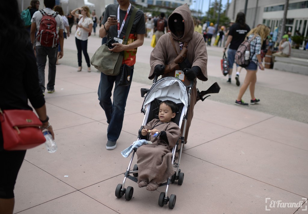 A person dressed as a character from "Star Wars" pushes a child in a stroller outside the San Diego Convention Center at Comic Con International 2015 in San Diego on July 10, 2015.  AFP PHOTO/ROBYN BECK