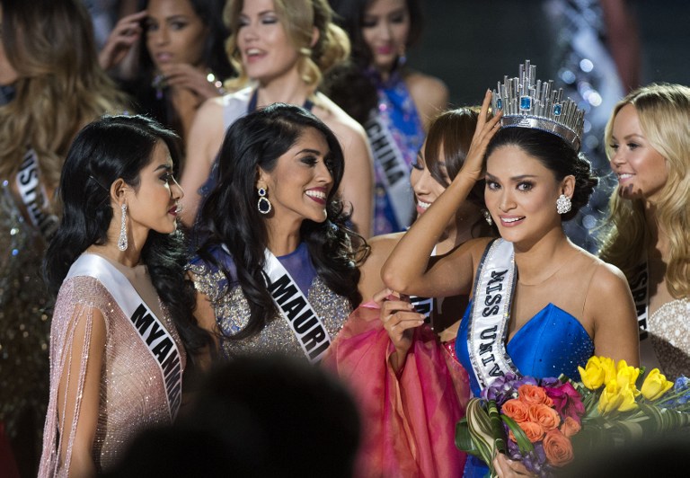 Miss Philippines Pia Alonzo Wurtzbach (R), Miss Universe 2015 is congratulated by pageant friends on stage during The 2015 MISS UNIVERSE Show at Planet Hollywood Resort & Casino, in Las Vegas, California, on December 20, 2015.   Miss Philippines was named Miss Universe, but in a drama-filled turn worthy of a telenovela.  The pageant's host comedian Steve Harvey, also a talk show host, misread the card which he said had Miss Colombia Ariadna Gutierrez as the winner.  AFP PHOTO / VALERIE MACON / AFP / VALERIE MACON