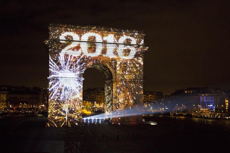 Art work is projected on Arc de Triomphe during a sound and light show part of New Year's celebrations on the Champs-Elysees avenue in Paris on January 1, 2016. AFP PHOTO/ FLORIAN DAVID / AFP / FLORIAN DAVID