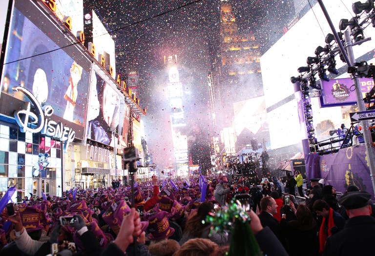 Revelers celebrate after the ball drop during New Year's Eve celebrations in Times Square on January 1, 2016 in New York. AFP PHOTO/ KENA BETANCUR / AFP / KENA BETANCUR