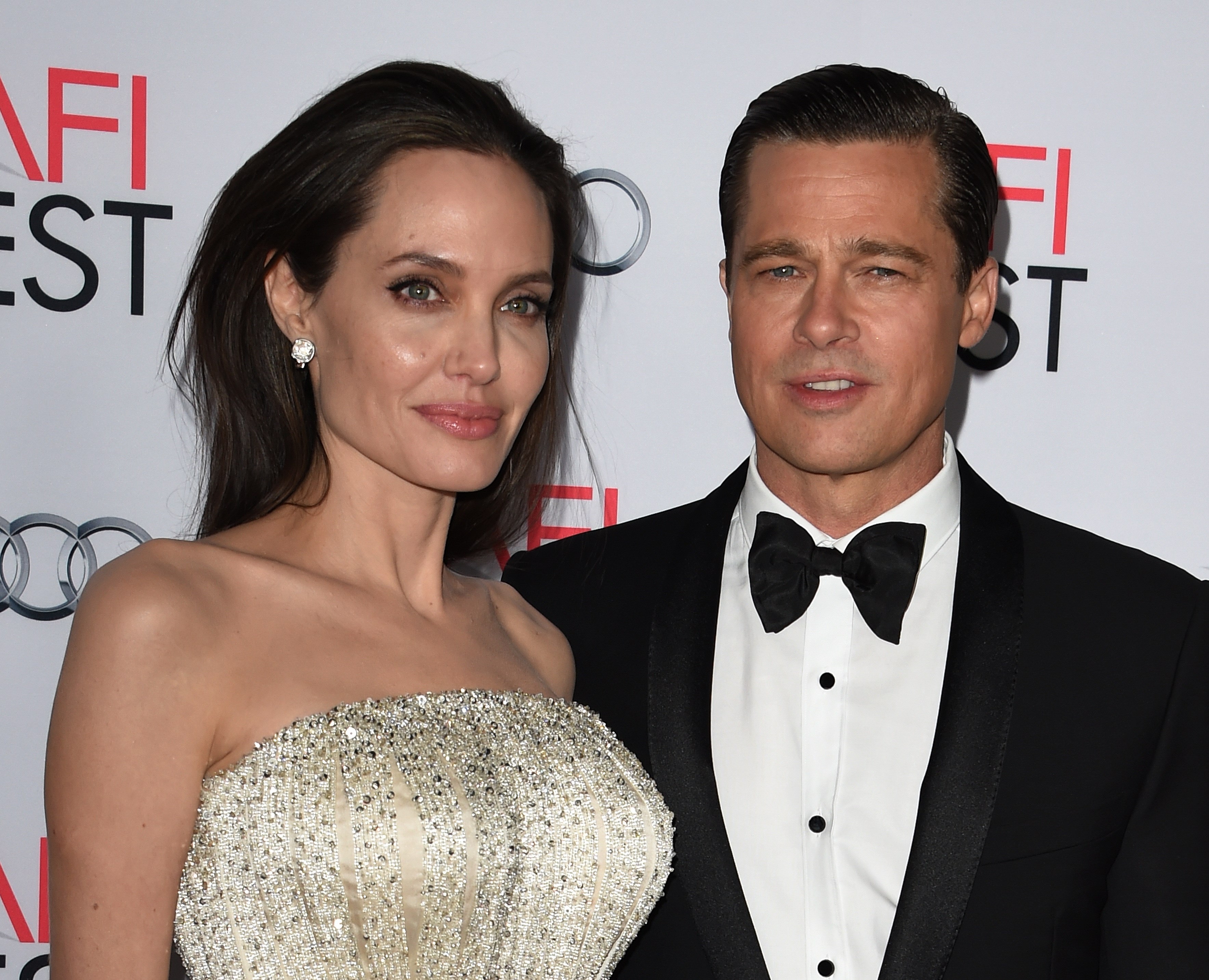 Writer-director-producer-actress Angelina Jolie Pitt (L) and actor-producer Brad Pitt arrive for the opening night gala premiere of Universal Pictures' 'By the Sea' during AFI FEST 2015 presented by Audi at the TCL Chinese Theatre in Hollywood, California on November 5, 2015.         AFP PHOTO / MARK RALSTON        (Photo credit should read MARK RALSTON/AFP/Getty Images)