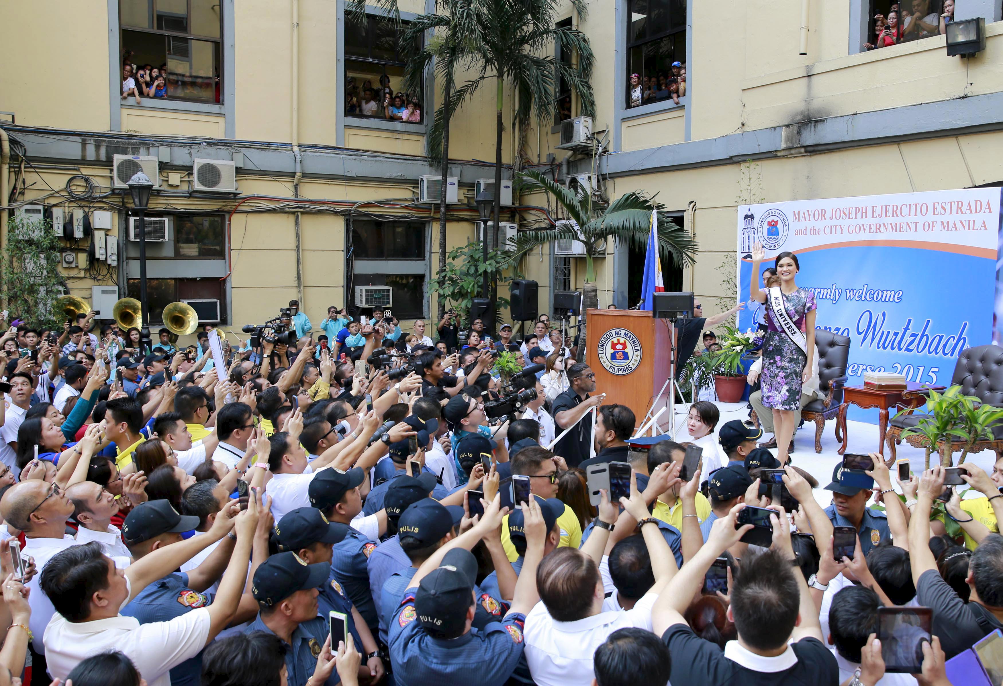 Miss Universe 2015 Pia Alonzo Wurtzbach waves to the crowds during her visit at the city hall of Manila January 25, 2016. Wurtzbach, the first Miss Universe from the Philippines in more than four decades, said on Sunday she will spend her reign bringing awareness to issues like HIV and draw support for countries vulnerable to disasters.  REUTERS/Romeo Ranoco