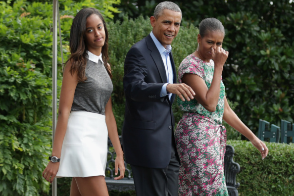 WASHINGTON, DC - AUGUST 09:  U.S. President Barack Obama (C), first lady Michelle Obama (R) and their oldest daughter Malia Obama (L) walk out of the White House before boarding Marine One August 9, 2014 in Washington, DC. Obama delivered a statement about the ongoing U.S. military actions and humanitarian drops in northern Iraq before he and his family traveled to Martha's Vineyard for a two-week vacation.  (Photo by Chip Somodevilla/Getty Images)