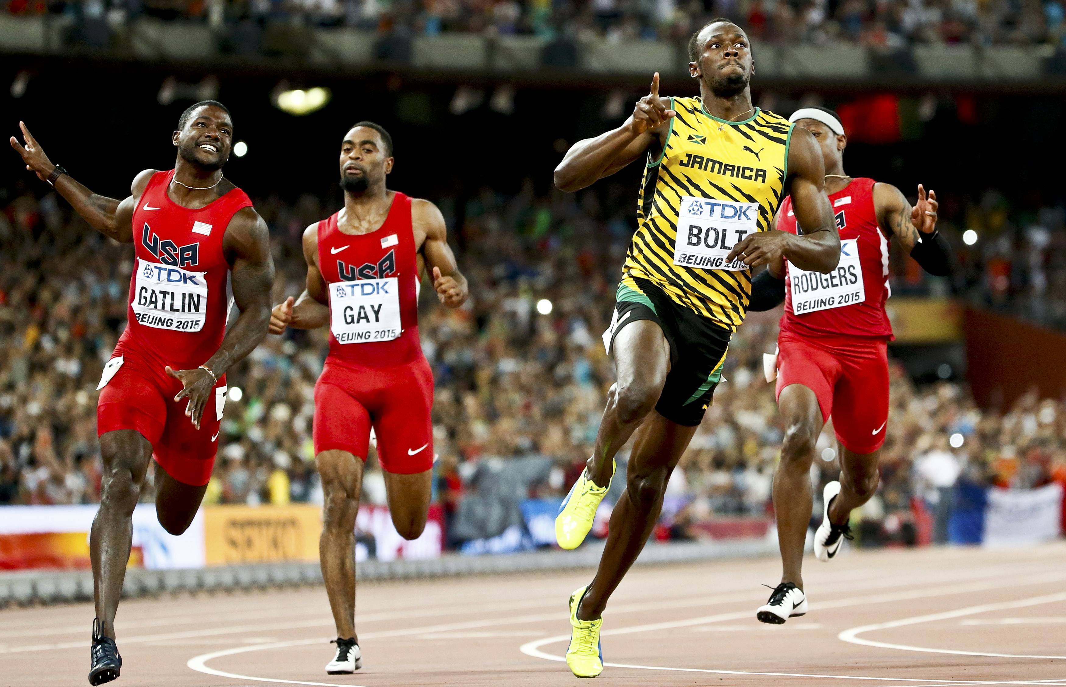 Justin Gatlin and Tyson Gay from the U.S. and Usain Bolt (L-R) of Jamaica compete in the men's 100m final during the 15th IAAF World Championships at the National Stadium in Beijing, China August 23, 2015.  REUTERS/Lucy Nicholson