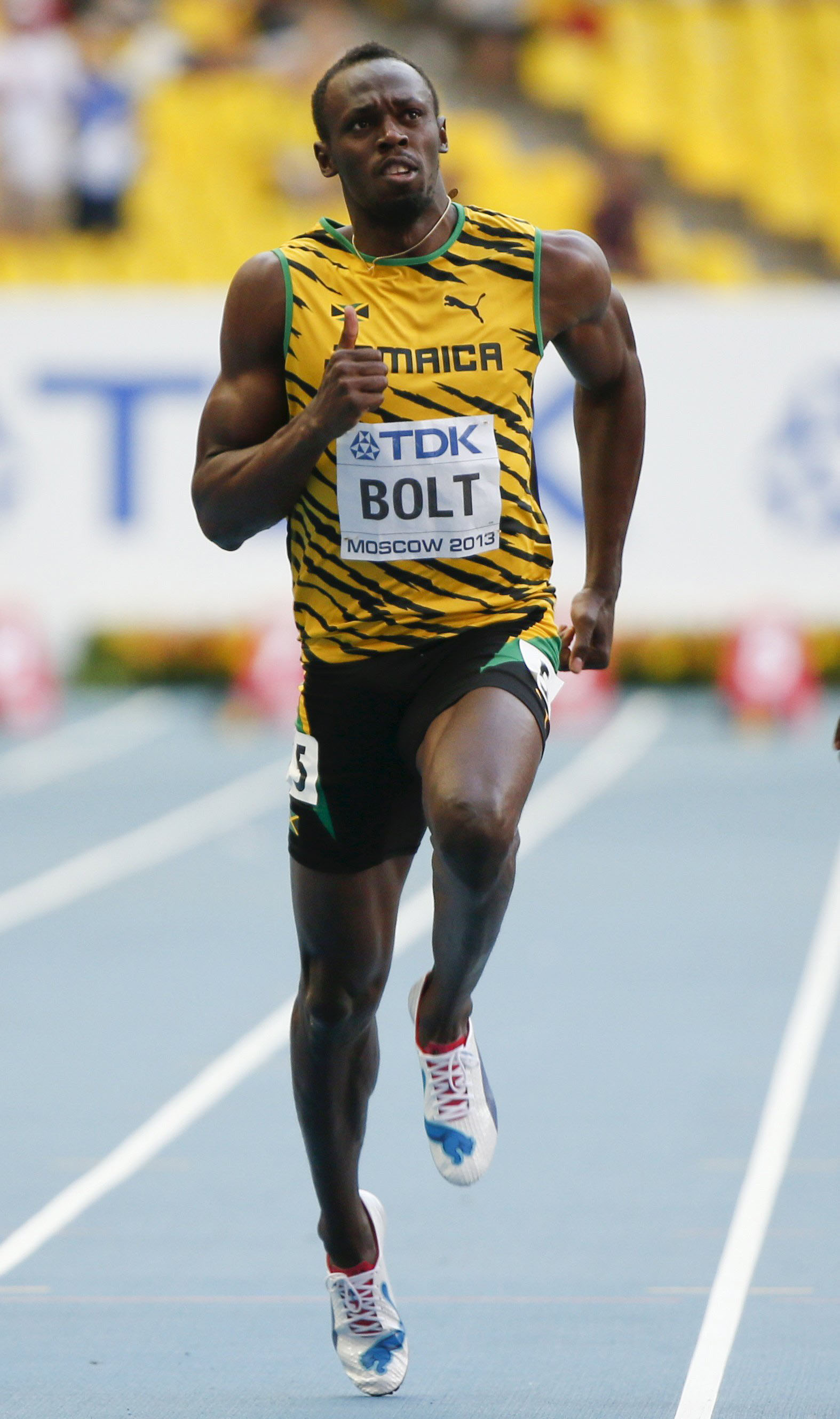 Usain Bolt of Jamaica competes in the men's 100 metres semi-final heat event during the IAAF World Athletics Championships at the Luzhniki stadium in Moscow, Russia, in this August 11, 2013 file photo. Bolt's coach is convinced the Jamaican phenomenon can once again put aside injury concerns and mediocre form to maintain his grip on the major sprint titles at this month's world championship. REUTERS/Lucy Nicholson/Files