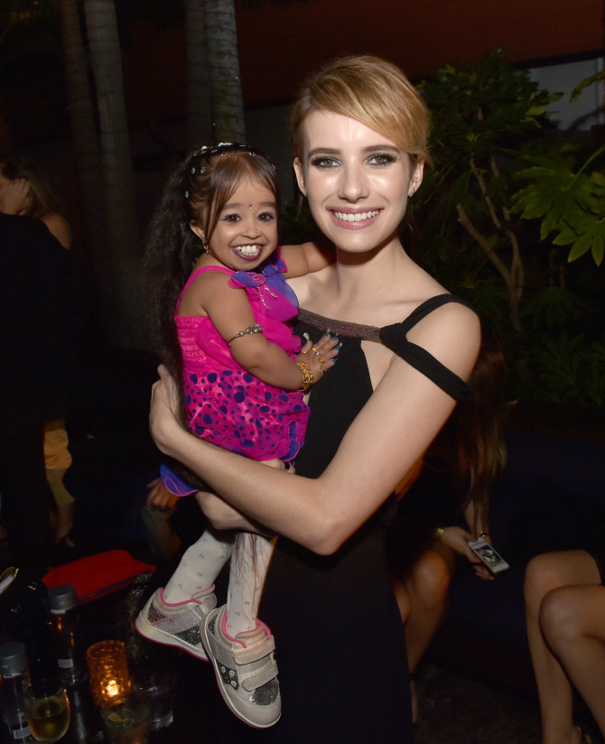 LOS ANGELES, CA - OCTOBER 05: Actresses Jyoti Amge (L) and Emma Roberts pose at the after party for the premiere screening of FX's "American Horror Story: Freak Show" at the Roosevelt Hotel on October 5, 2014 in Los Angeles, California. (Photo by Kevin Winter/Getty Images)