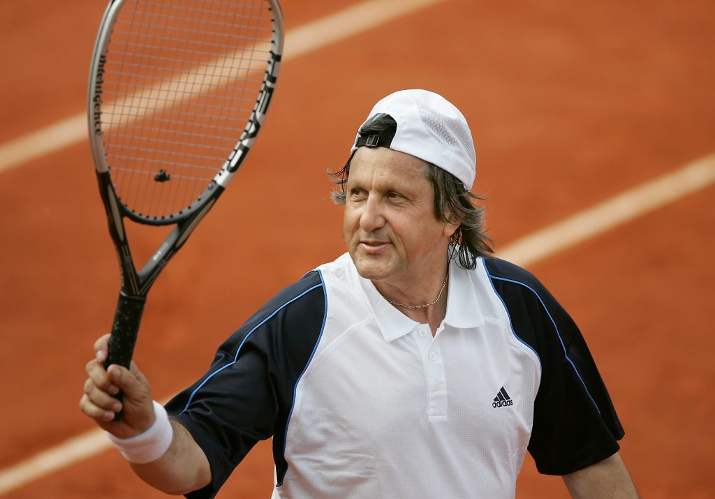 Romanian Ilie Nastase greets the crowd during his double match with Argentinian Jose-Luis Clerc against French Yannick Noah and US John McEnroe at the Roland Garros tennis French Open, 31 May 2005 in Paris. AFP PHOTO JACQUES DEMARTHON