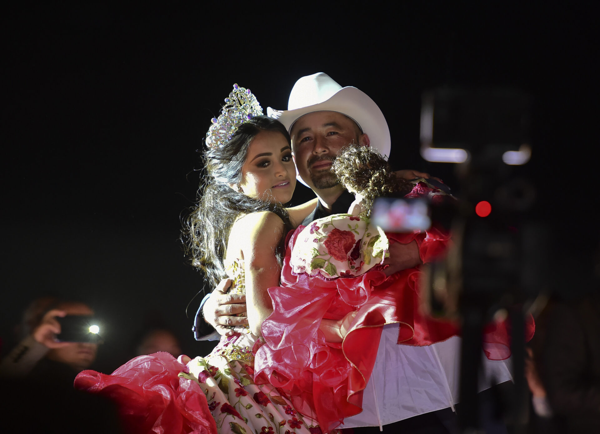 Rubi Ibarra and her father Cresencio Ibarra dance during the celebration of her 15th birthday in Villa Guadalupe, San Luis Potosi State, on December 26, 2016.  Rubi, a small-town Mexican teen, welcomed thousands of guests for her 15th birthday party  after her parents' video invitation to the milestone event went viral online.  / AFP PHOTO / RONALDO SCHEMIDT