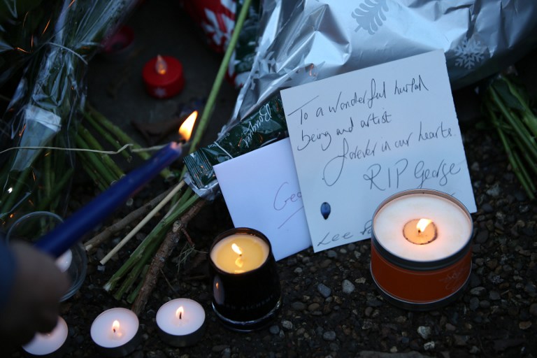 Messages and candles are seen among floral tributes outside the north London home of British singer George Michael on December 26, 2016, after news of the singer's death broke. Tributes poured in from the music world on December 26 after British pop superstar George Michael, who rose to fame with the duo Wham! and a string of smash hits including "Last Christmas", died aged 53. Michael died of apparent heart failure on Christmas Day at his home in Goring, a village on the River Thames in Oxfordshire, west of London, after an award-winning career spanning more than three decades. / AFP PHOTO / Daniel LEAL-OLIVAS