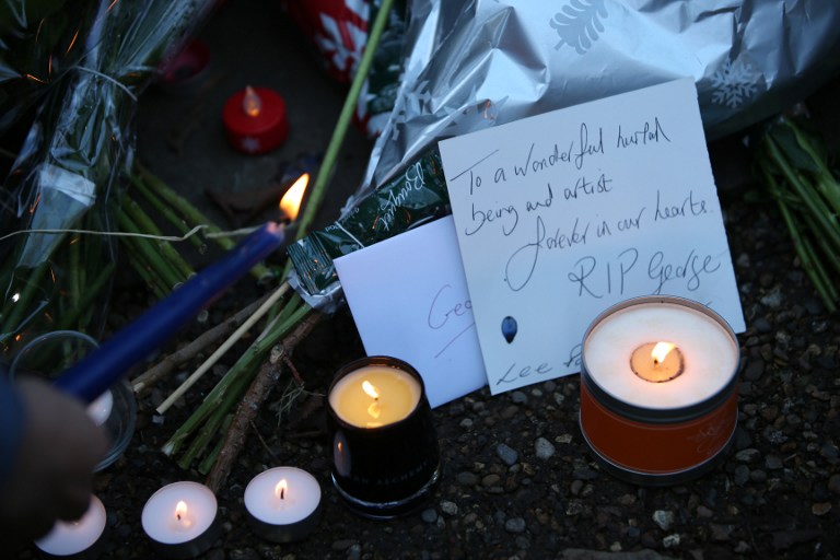 Messages and candles are seen among floral tributes outside the north London home of British singer George Michael on December 26, 2016, after news of the singer's death broke.  Tributes poured in from the music world on December 26 after British pop superstar George Michael, who rose to fame with the duo Wham! and a string of smash hits including "Last Christmas", died aged 53. Michael died of apparent heart failure on Christmas Day at his home in Goring, a village on the River Thames in Oxfordshire, west of London, after an award-winning career spanning more than three decades. / AFP PHOTO / Daniel LEAL-OLIVAS