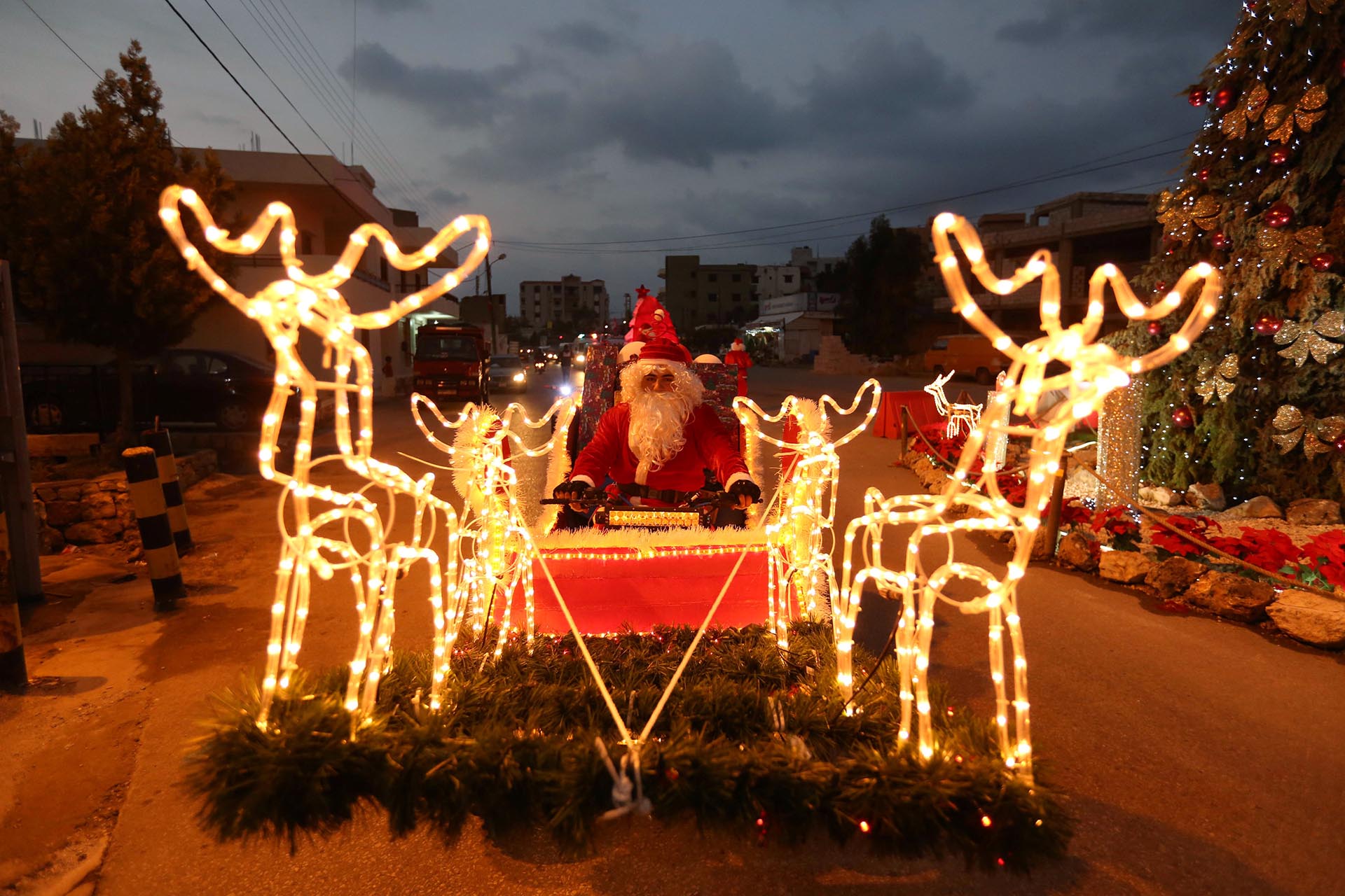 A man dressed as Santa Claus rides a Christmas decorated vehicle in Jiyeh, south Lebanon December 23, 2016. REUTERS/Aziz Taher TPX IMAGES OF THE DAY